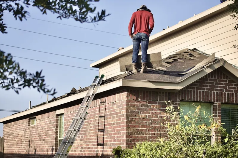 Professional roofer working on a residential roof in Baldwin Hills